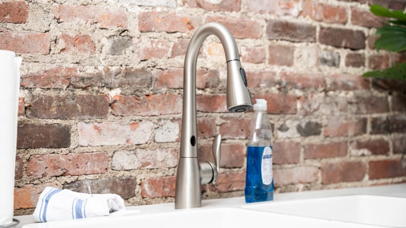 A silver faucet is attached to a white kitchen sink