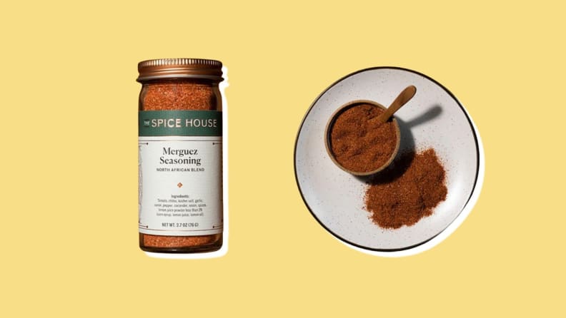 Spice House jar of Merguez seasoning next to place of seasoning with scoop.