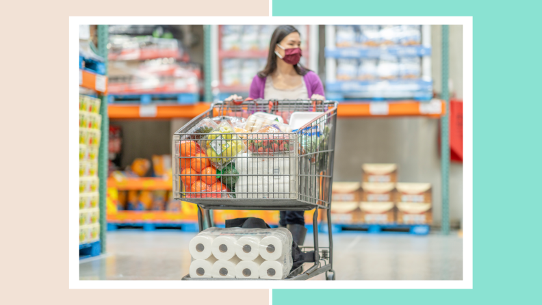 Person pushing around shopping cart filled with food from wholesale supermarket.