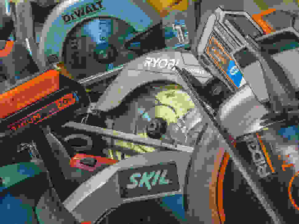 The image contains a piled assortment of circular saws.