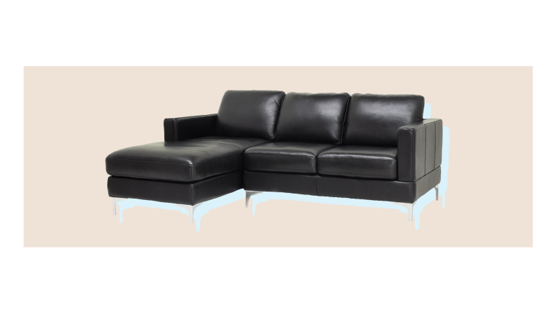 A leather sofa in front of a background.
