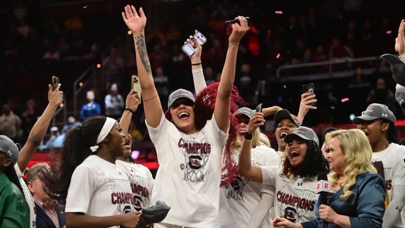 Kamilla Cardoso celebrating the NCAA championship with her teammates.