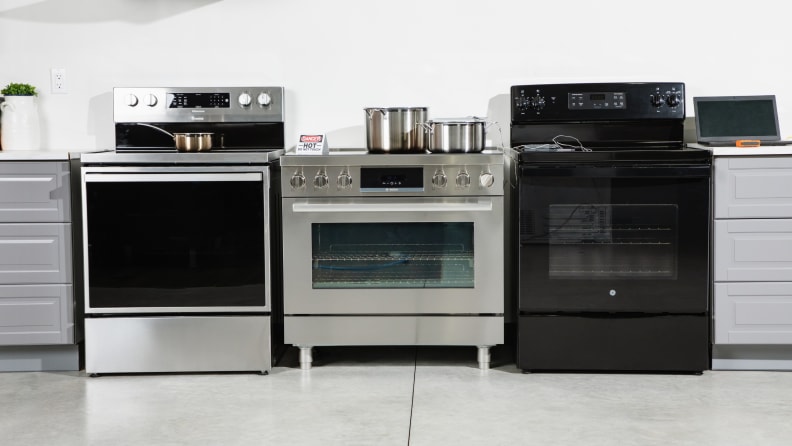 Three different range's side-by-side in the colors black and silver, being tested by Reviewed Kitchen editors.