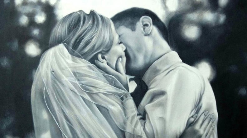 black and white portrait of married couple kissing