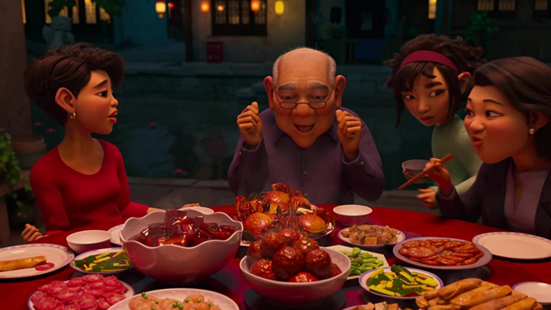 A still from the film Over the Moon featuring the main character and her family around a table, eating a meal.
