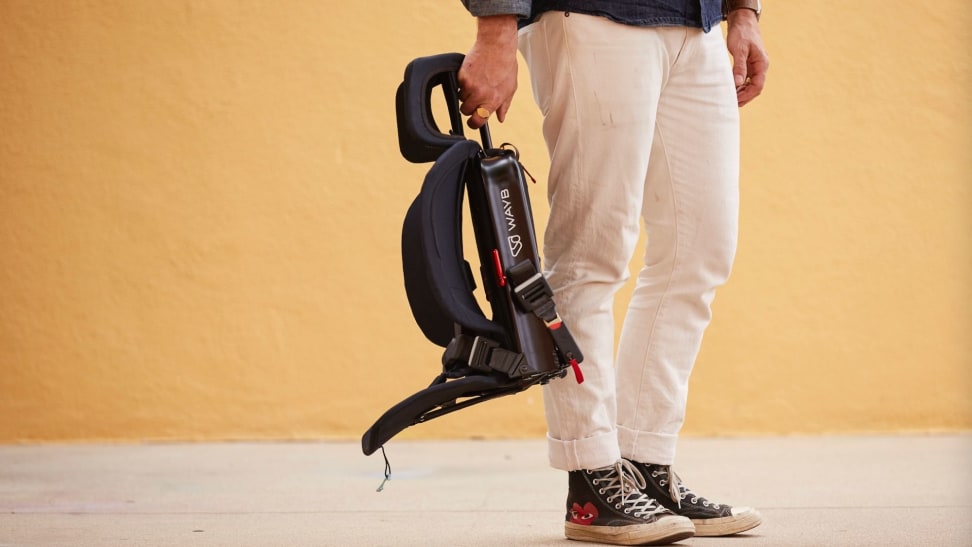 A man holds the thin-framed Pico car seat.