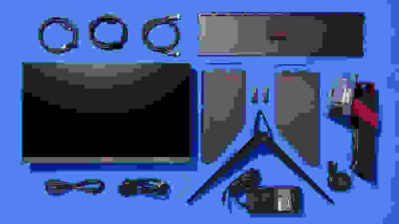 The AGON PRO monitor and accessories laid out next on a blue background.