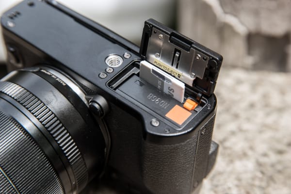 The battery bay on the X-T10 houses the removable battery and SD card slot.