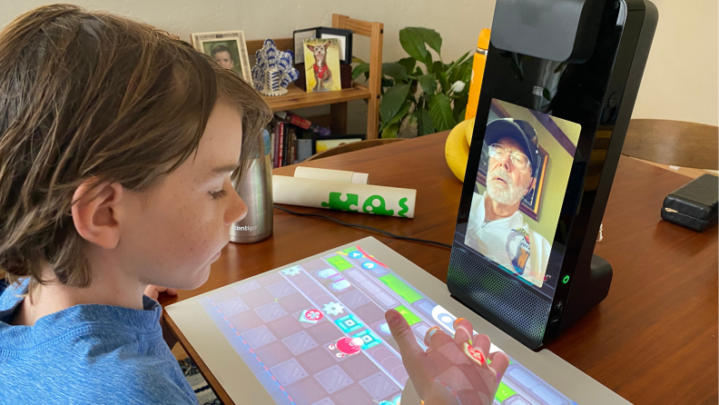 A child plays on the Amazon Glow with their grandparent.