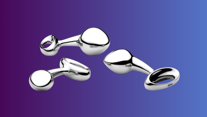 An anal sex toy sits on an indigo fade background