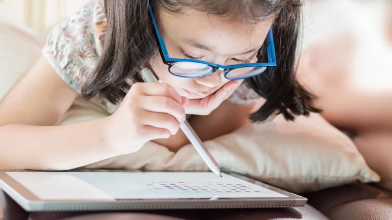 girl using a tablet with a stylus