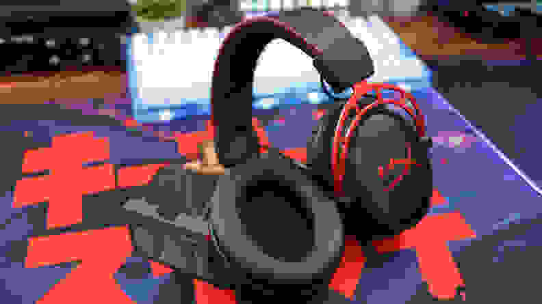 A black and red gaming headset with one earcup facing the camera