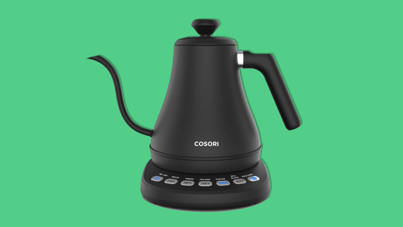 The Cosori electric gooseneck kettle on a green background is a college dorm room essential.