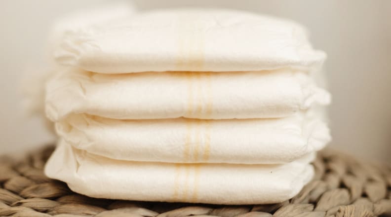 A stack of four diapers from Dyper sits in a pile.