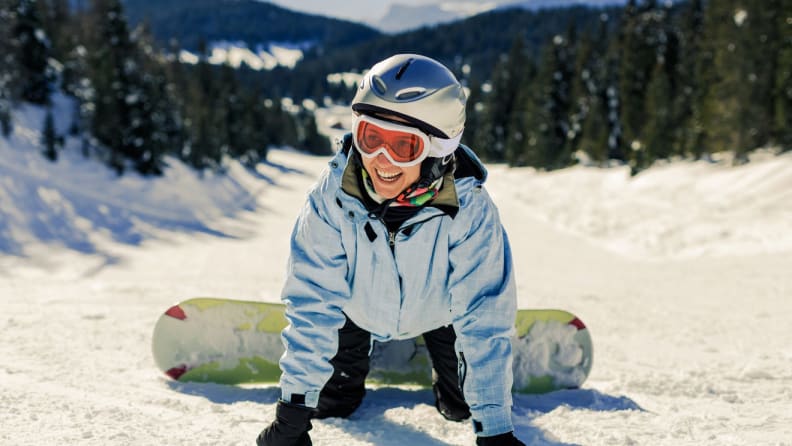Person having fun while snowboarding outdoors.