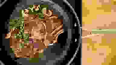 Photo of KitchenAid Nitro Carbon Steel Fry Pan cooking a seared steak and herbs.