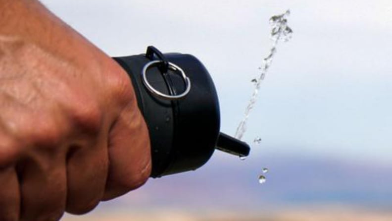 Hand squeezing Tushy Travel with water squirting out