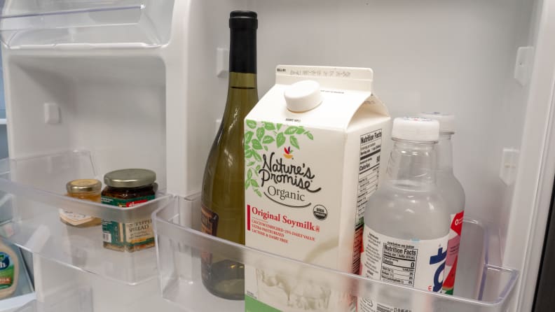 A close-up of the storage options lining the GE GTS22KGNRBB top-freezer refrigerator's door.