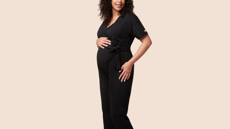 A woman wearing the 1. Mori Maternity & Nursing Jumpsuit in the color black.