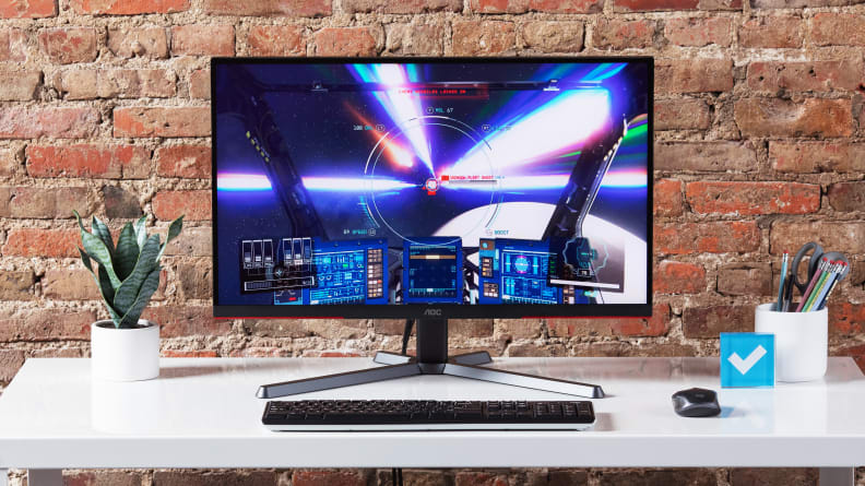 The AOC Q27G3XMN, one of the best gaming monitors owing to its low price, showing a ship in space