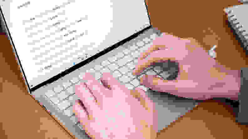 A person types on the keyboard