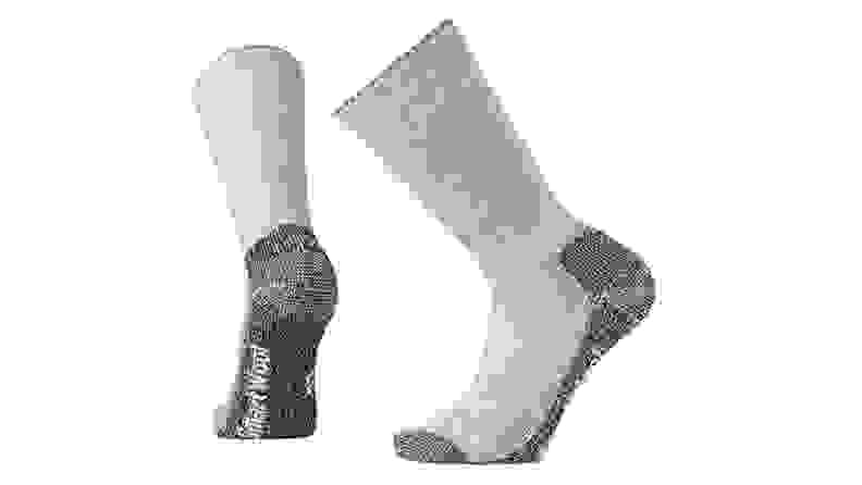 A pair of wool socks are shown as if being worn, or in motion, against a white backdrop.