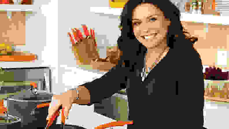 Rachael Ray standing by stove cooking