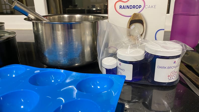 silicone moulds, saucepans and other kitchen essentials on a granite counter