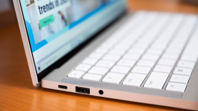 The laptop's left side, showing a USB port, a Thunderbolt port, and an audio jack.