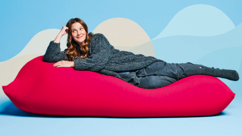 Drew Barrymore lounges on a red Yogibo Max.