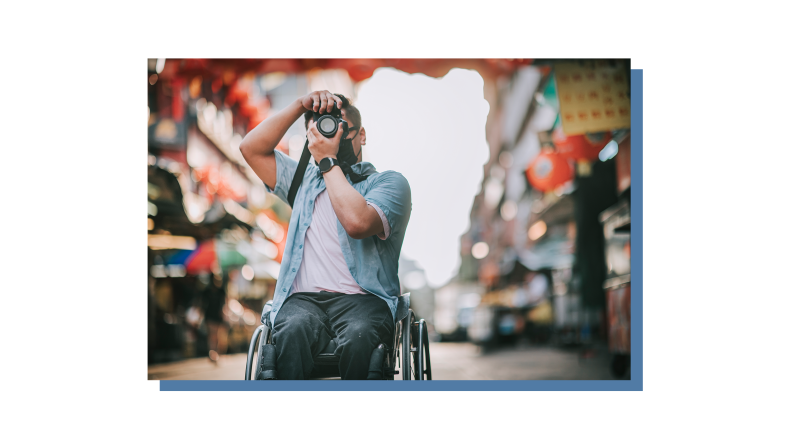 A person in a wheelchair using a camera.