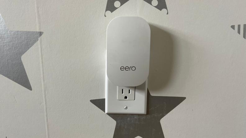 An Eero Beacon plugged into an outlet.