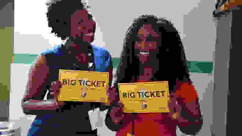 Two black women holding signs reading "Big Ticket"