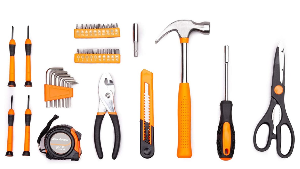 Tools including a hammer, screwdriver, pliers, and scissors are arranged.