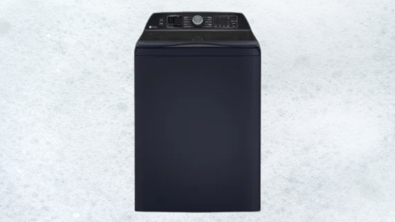 A dark blue washing machine sits on a white sudsy background