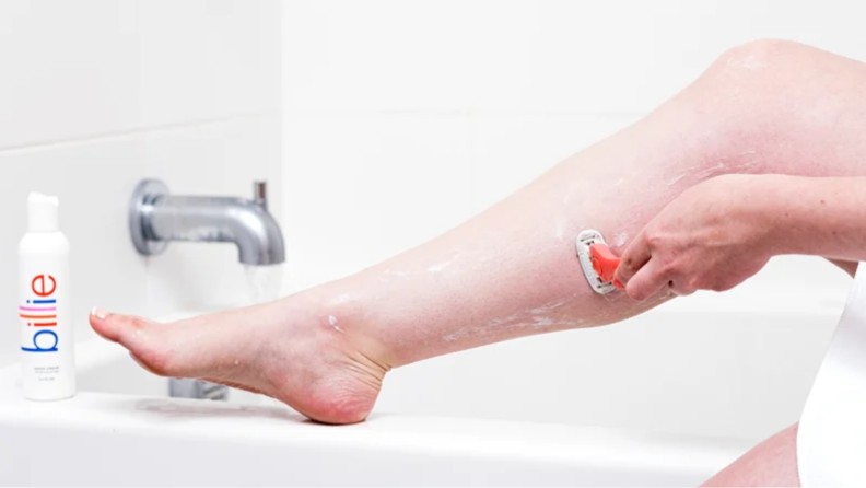 An image of a Billie razor being used to shave someone's calves.