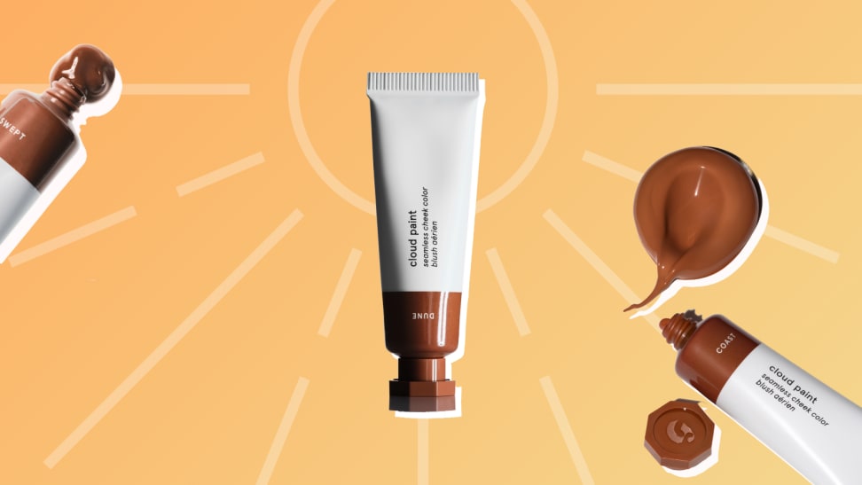 Three Glossier Cloud Paint Bronzers against a sun and orange and yellow background.