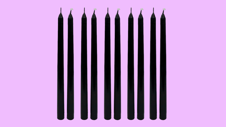 An image of ten black taper candles.