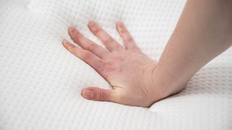 a hand presses into the Brooklyn Signature Hybrid