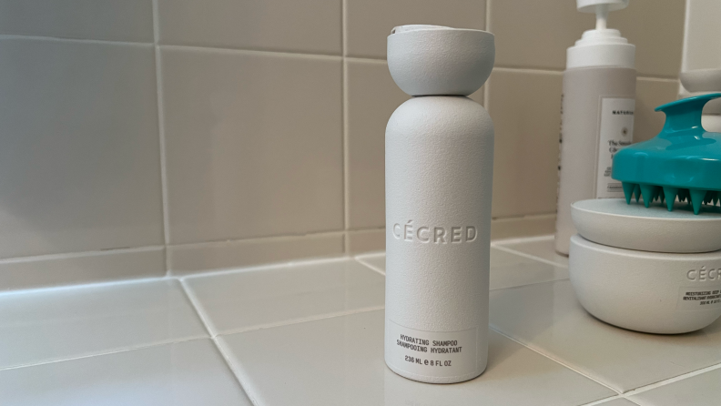 A bottle of Cecred shampoo on a countertop.