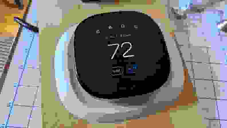 An Ecobee smart thermostat appears set up for testing at the reviewer's home.