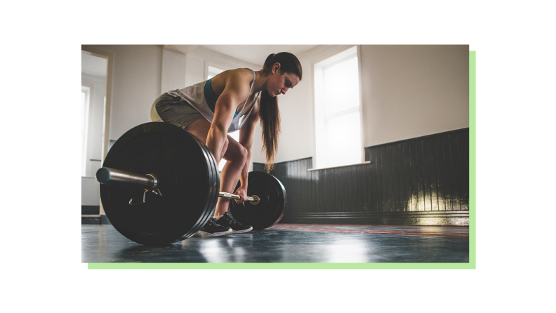 A person holding a barbell ready to lift it up.