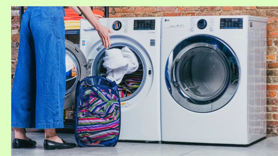 Person throwing in dirty laundry into the washer next to a dryer