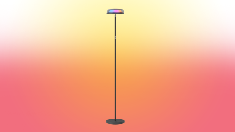 A lamp stands on a red and yellow fade background