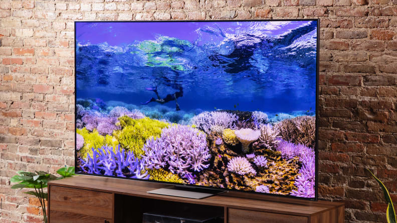 TCL 75R655 with underwater display in front of brick wall indoors.