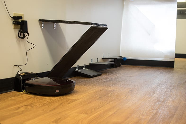Wooden shelves and wedge in the robot vacuum testing arena