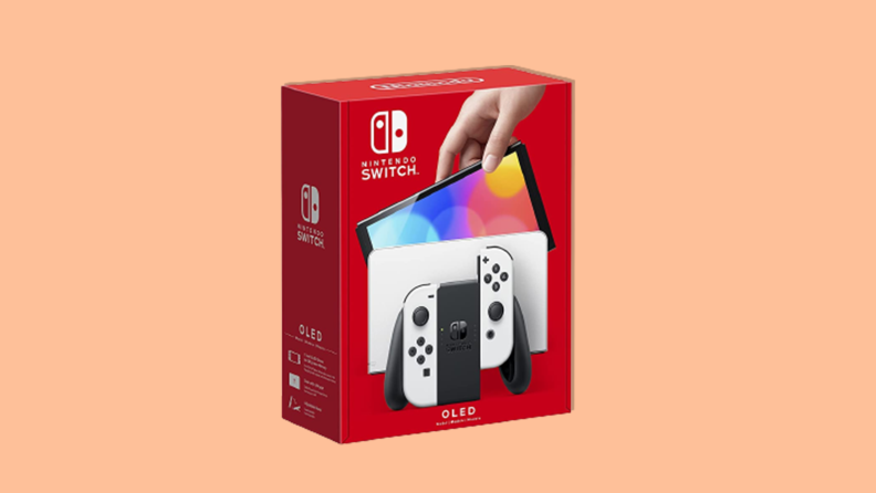 The Nintendo Switch OLED in its box on an peach background.