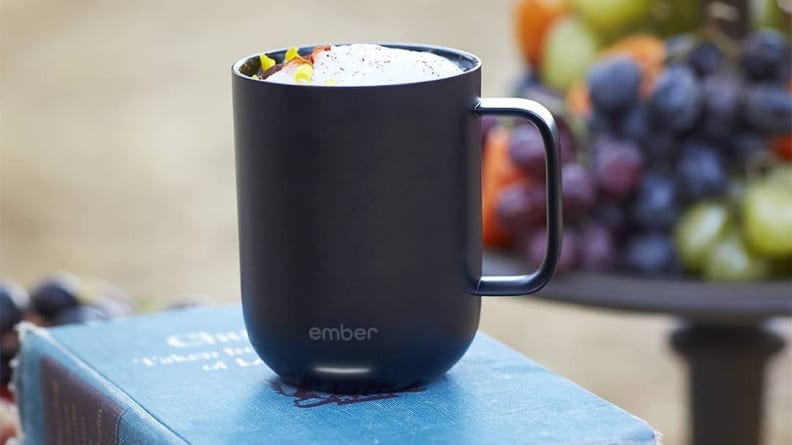 Mug filled with beverage on a book.