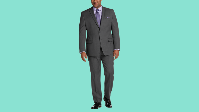 A gray suit against a teal background.