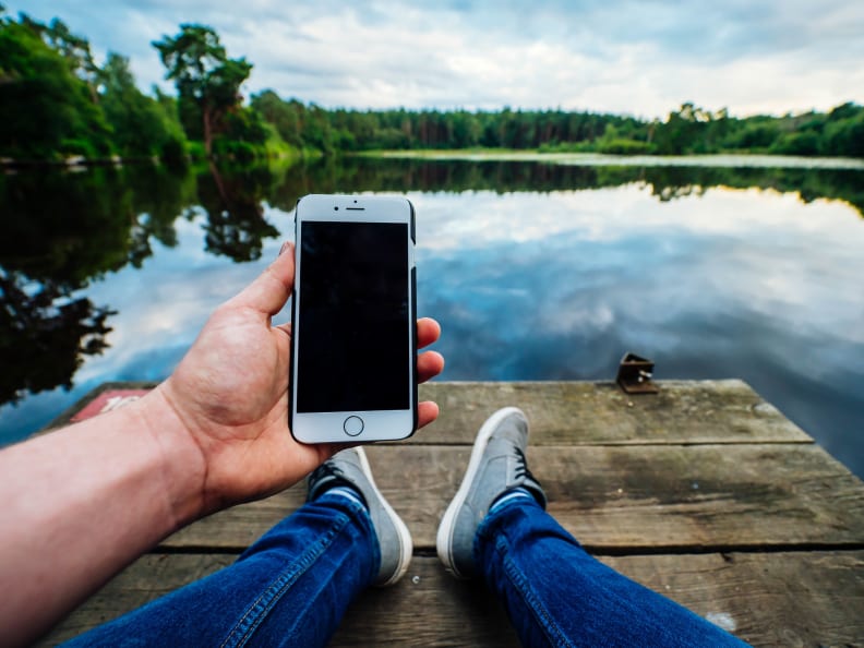 Smartphone on deck by lake